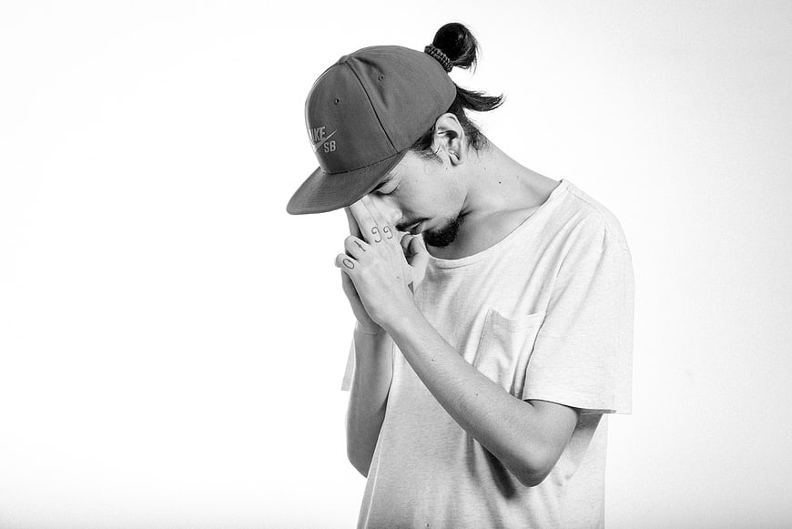 Black and white portrait of man meditating with hands clasped
