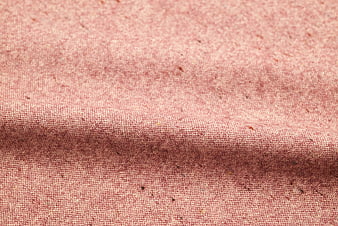 Close-up of textured pink linen fabric with natural weave