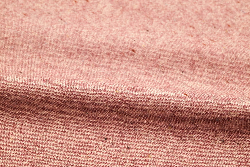 Close-up of textured pink linen fabric with natural weave