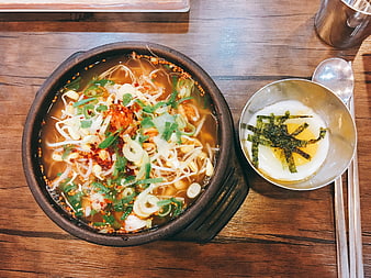 Korean Spicy Noodle Soup With Egg And Seaweed On Wooden Table
