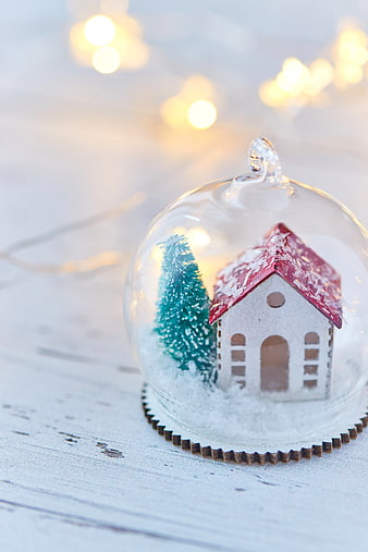 Christmas snow globe with miniature house and tree