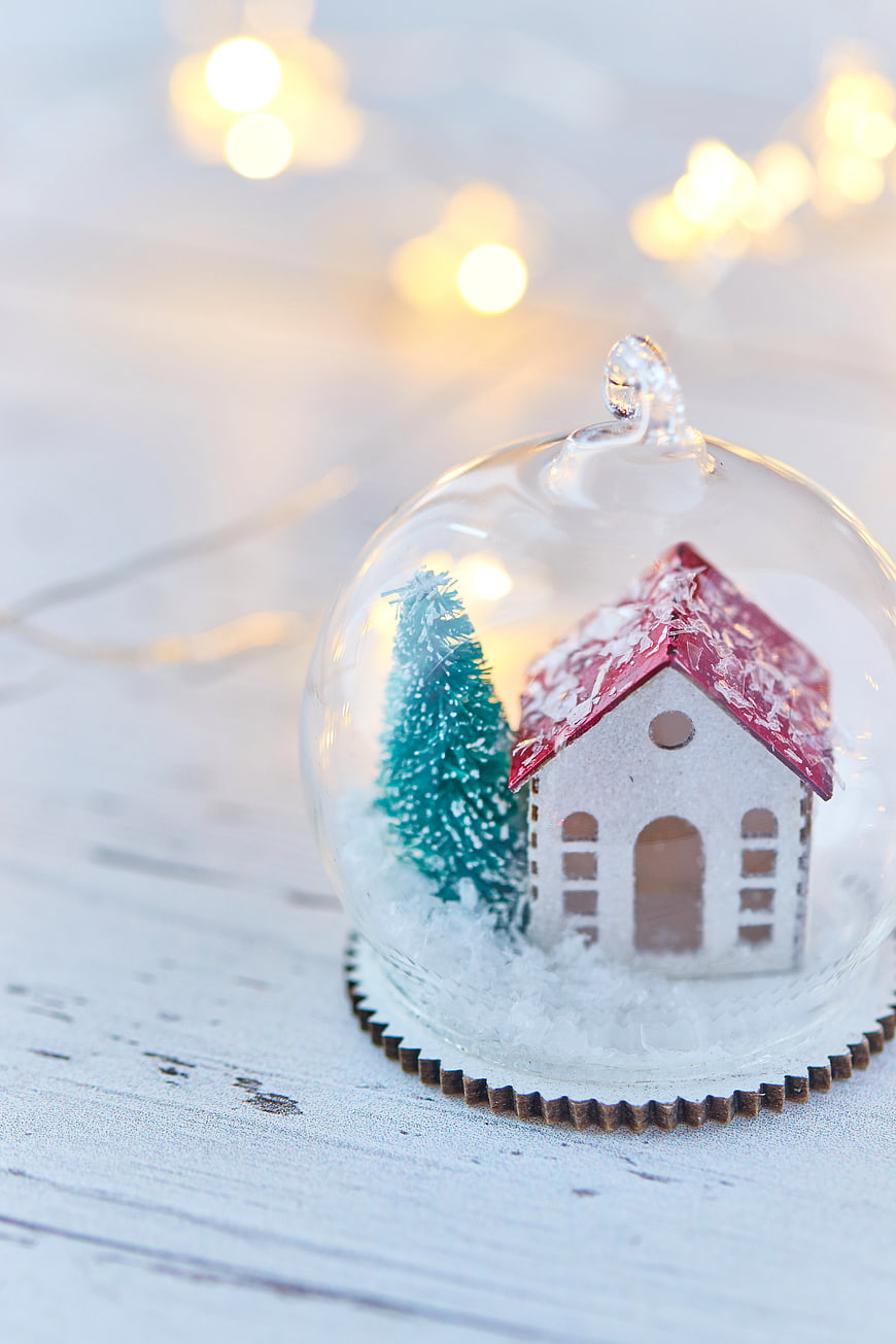 Christmas snow globe with miniature house and tree