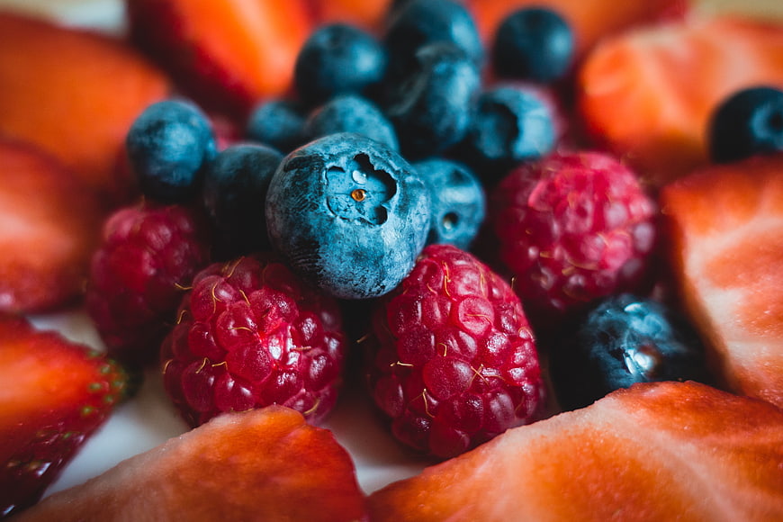 Close-up of fresh blueberries, raspberries, and sliced strawberries