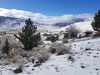 Snowy suburban neighborhood nestled in mountain valley