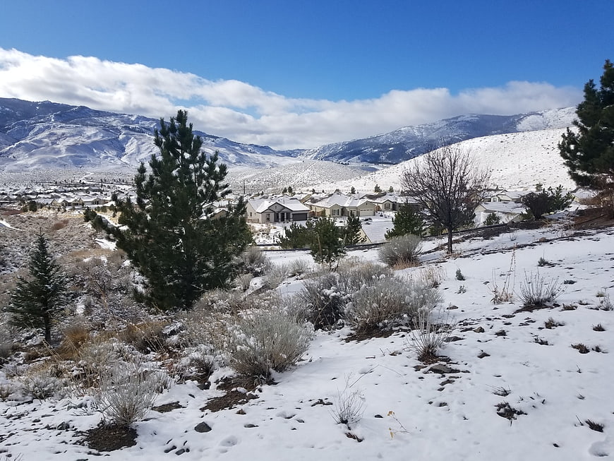 Snowy suburban neighborhood nestled in mountain valley