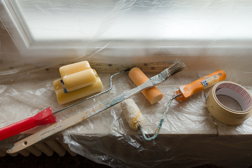 Painting Tools And Supplies On Plastic Drop Cloth