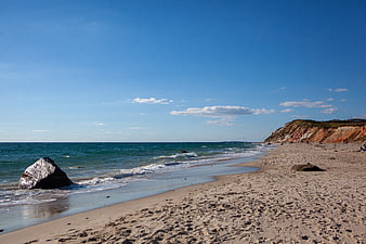 Sandy Beach with Colorful Cliffs and Blue Ocean