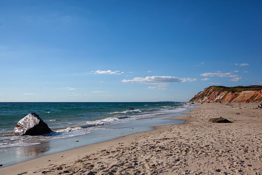 Sandy Beach with Colorful Cliffs and Blue Ocean