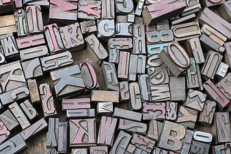 Vintage metal letterpress printing blocks scattered close up