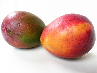 Two Ripe Tropical Mangoes On White Background