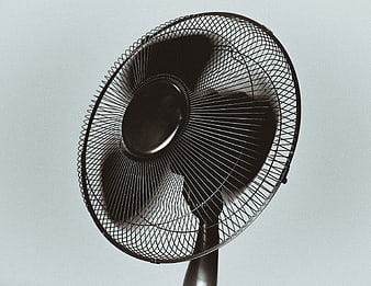 Black Electric Fan Against Light Gray Background