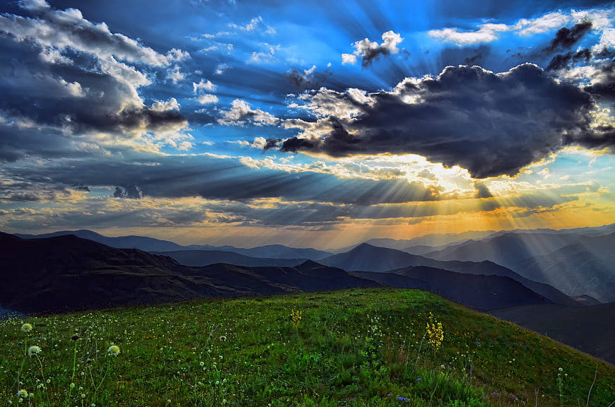 Dramatic Sun Rays Over Mountain Meadow Landscape