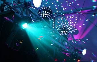 Vibrant nightclub stage lighting with disco balls and colorful beams