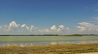 Panoramic View of Zicksee Lake with Cumulus Clouds and Low Water Levels