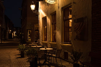 Cozy European Street Cafe at Night with Warm Lighting