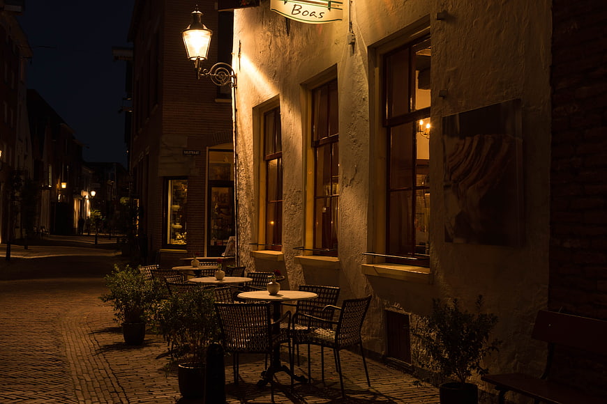 Cozy European Street Cafe at Night with Warm Lighting