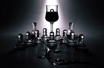 Glass Chess Pieces Surrounding Wine Glass with Dark Liquid