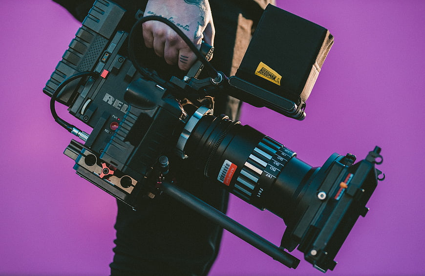 Professional Cinema Camera with Matte Box on Purple Background