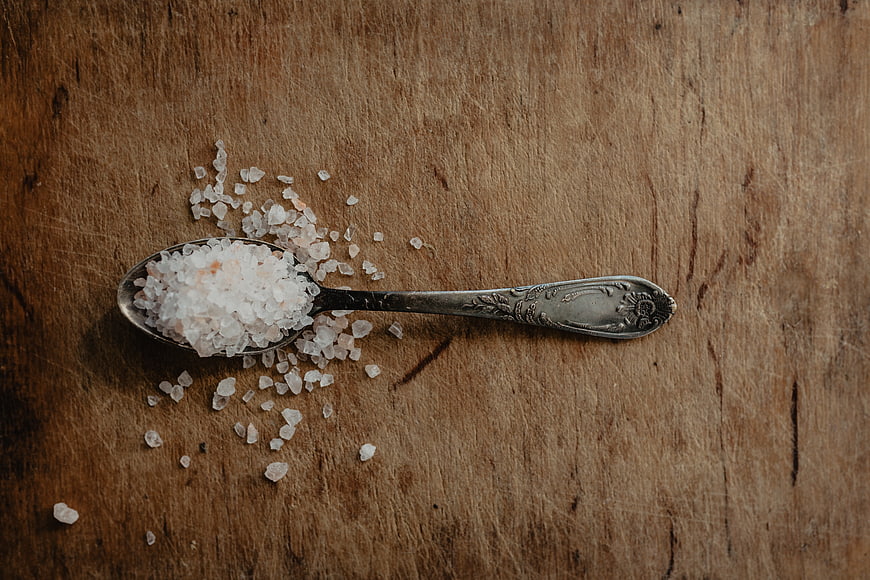Vintage Spoon with Himalayan Pink Salt on Wooden Table