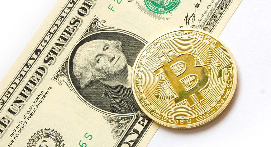 Physical Bitcoin Coin on US Dollar Bill