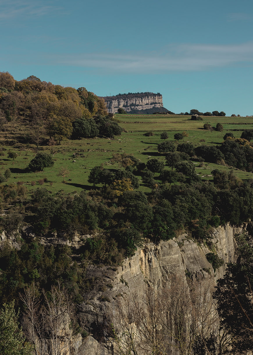Scenic landscape with limestone cliffs and autumn forest