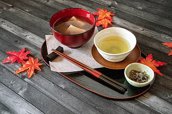 Japanese Autumn Meal With Miso Soup, Green Tea, and Maple Leaves