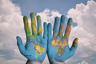 World Map Painted on Hands Against Cloudy Sky