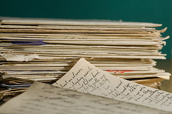 Stack of vintage handwritten letters on a desk