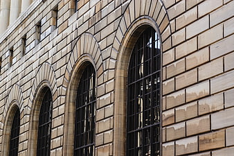 Arched stone windows on a historic building facade