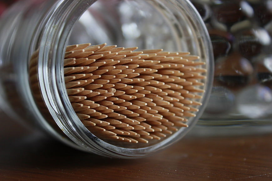 Close-up of wooden toothpicks in a glass jar