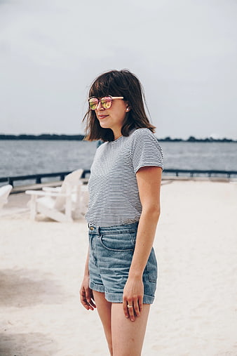 Woman in Striped Shirt and Denim Shorts on Beach