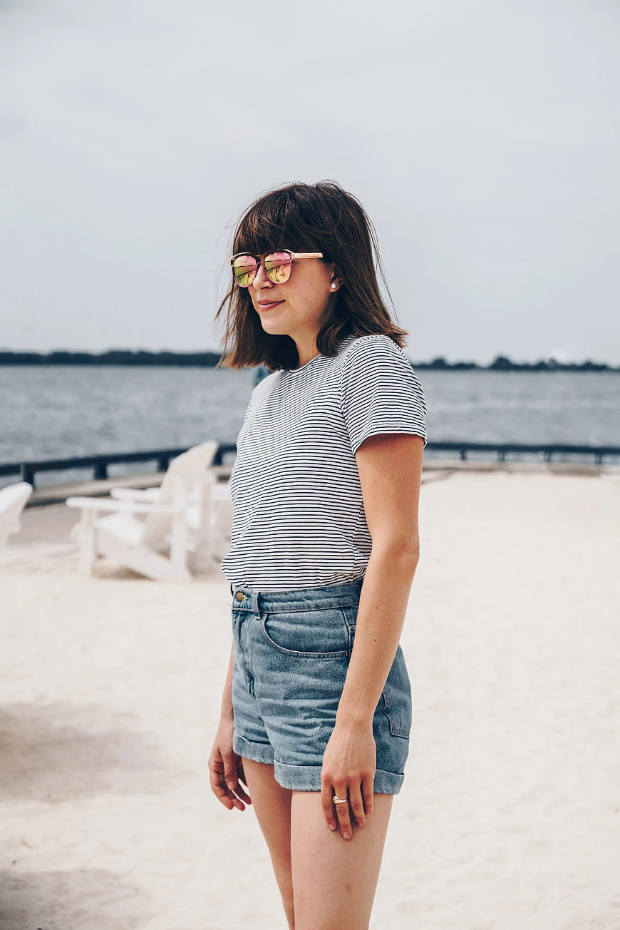 Woman in Striped Shirt and Denim Shorts on Beach