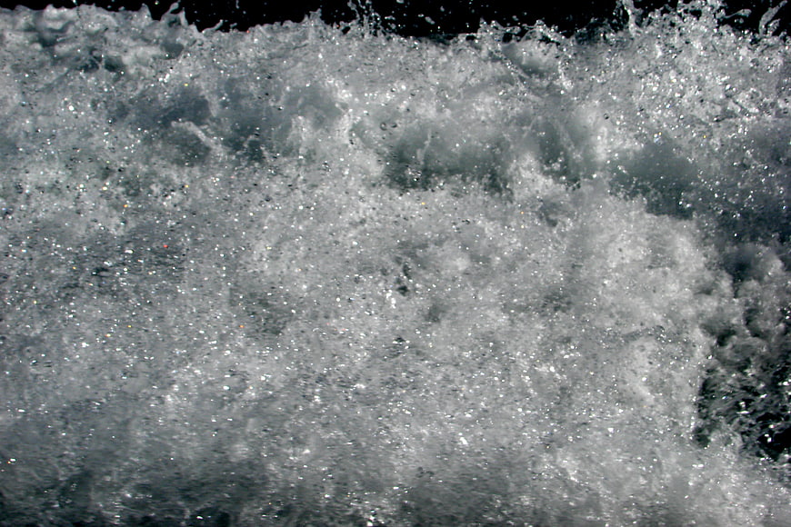 Close-up texture of splashing white water foam and bubbles