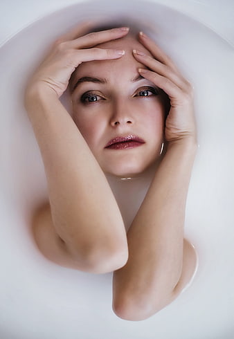 Woman in Milk Bath with Glitter Makeup
