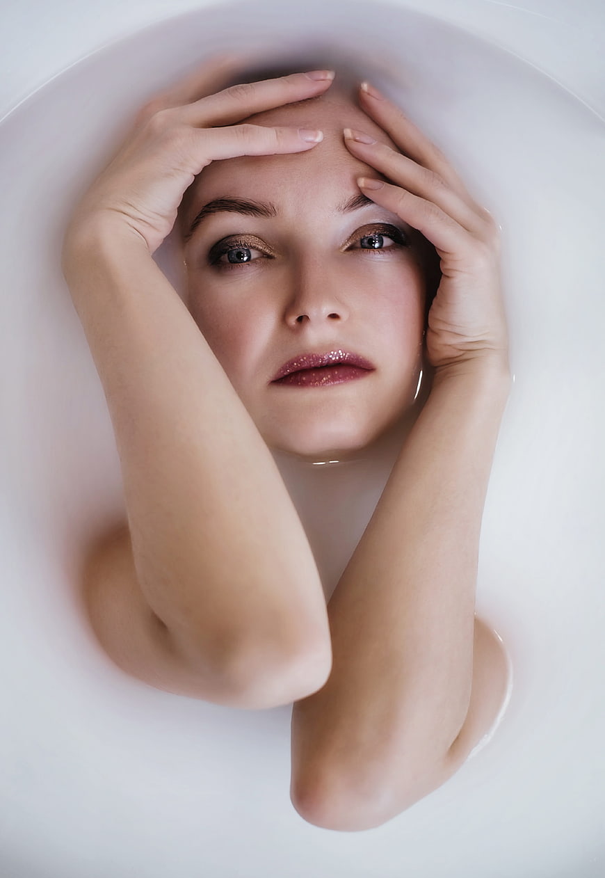 Woman in Milk Bath with Glitter Makeup