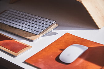 Minimalist Workspace with Wooden Keyboard Stand and Leather Mousepad