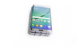 Stack of silver smartphones on white background