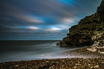 Long Exposure Rocky Coastline with Misty Ocean Waves