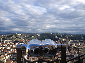 Binoculars overlooking Siena cityscape and Tuscan hills