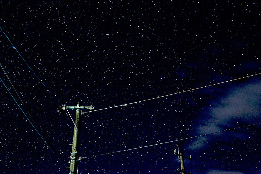 Night Sky with Stars and Utility Poles
