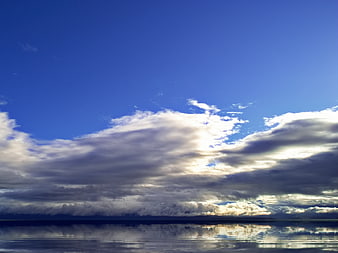 Dramatic Clouds Over Calm Ocean Horizon