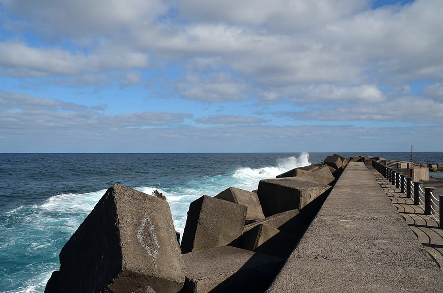 Concrete Breakwater with Ocean Waves and Blue Sky