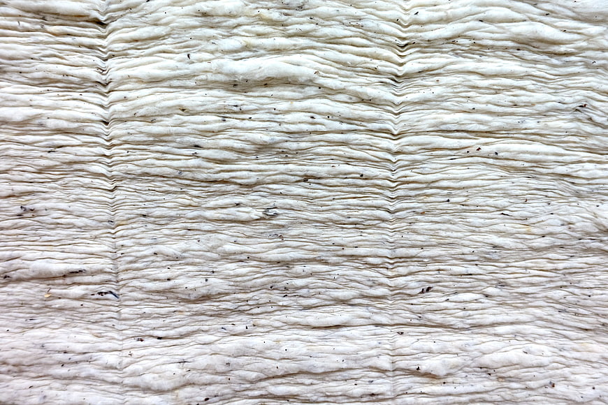 Close-up of textured white layered material with wavy pattern