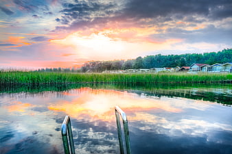 Serene Sunset Reflection on Natural Pool with Ladder