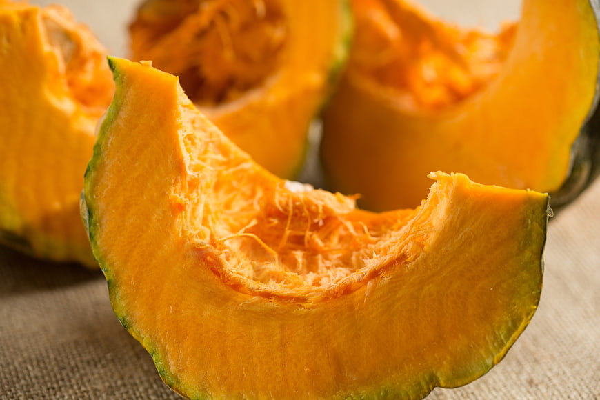 Fresh Sliced Pumpkin on Rustic Burlap Background
