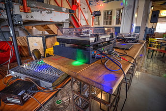 DJ turntable and mixer setup on wooden table