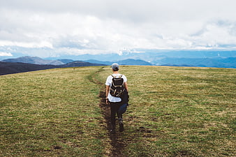 Hiker Walking on Mountain Trail with Backpack