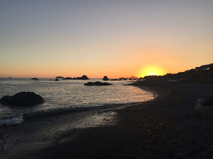 Sunset over rocky Oregon coast beach with ocean waves