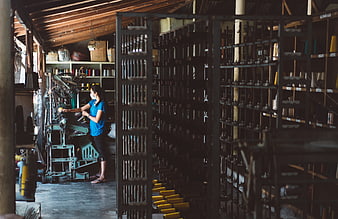 Woman operating textile machinery in a workshop