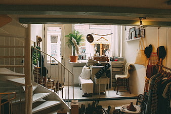Cozy Vintage Interior with Staircase and Clothing Rack
